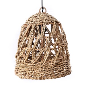 May include: A woven, bell-shaped lampshade made of natural, light brown fibers. The lampshade has a geometric pattern and is hanging from a black cord.