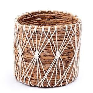May include: A woven seagrass basket with a white rope design. The basket is round and has a natural brown color.