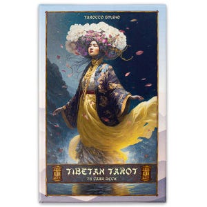 May include: Tibetan Tarot 78 Card Deck box featuring a woman in a yellow dress and blue robe with a floral crown. The background is a dark blue with mountains and water.
