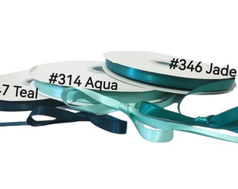 May include: Three spools of satin ribbon in shades of teal, aqua, and jade. The spools are labeled with the color names and numbers: #347 Teal, #314 Aqua, and #346 Jade.