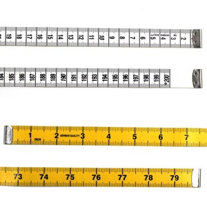 May include: Three measuring tapes, two are yellow and one is white. The yellow tapes have markings in inches and the white tape has markings in centimeters. The white tape has the text "GERMAN QUALITY" and "CM" printed on it. The yellow tapes have the text "GERMAN QUALITY" and "INCH" printed on them.