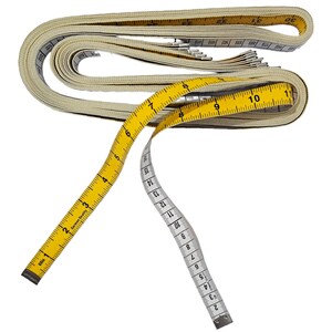 May include: A yellow and white measuring tape with a white fabric casing. The tape is coiled and the end of the tape is extended. The tape has numbers from 1 to 30 printed on it.