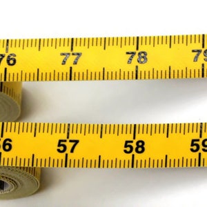 May include: Two yellow measuring tapes with black numbers. The top tape shows numbers 75 through 79. The bottom tape shows numbers 56 through 59.