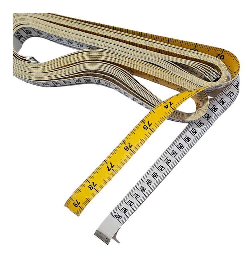 May include: A yellow and white measuring tape with black markings. The tape is extended to show the numbers 74 to 200. The tape is rolled up and the end is visible.