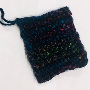 May include: A small, black knitted pouch with a rainbow yarn design and a loop handle.