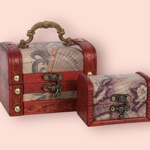 May include: Two wooden treasure chests with a vintage world map design. The larger chest has a brass handle and a latch. The smaller chest has a latch. Both chests have a brown and red finish.