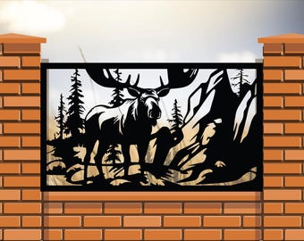 May include: Black metal fence panel with a silhouette of a moose standing in a forest setting. The panel is mounted on a brick wall.