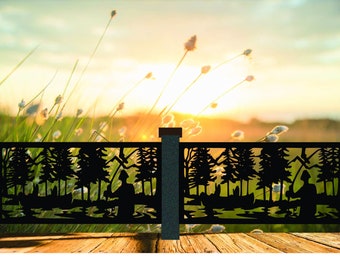 May include: Black metal fence panel with a silhouette design of a person fishing in a forest. The fence panel is set against a backdrop of a sunset and tall grass.