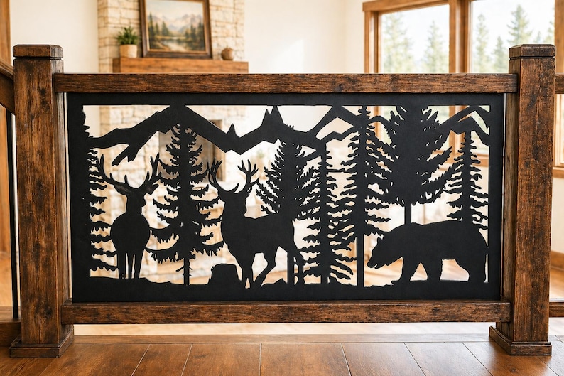 May include: A rectangular black metal railing insert featuring a laser-cut silhouette design of two deer, a bear, pine trees, and mountain peaks. The metal panel is framed by dark brown stained wooden posts and horizontal railing beams.