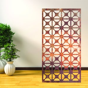 May include: A rusty metal room divider with a geometric pattern of overlapping circles. The divider is standing on a wooden floor in front of a white wall.