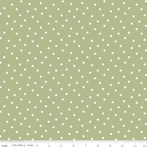 May include: A green fabric with a white polka dot pattern. The dots are evenly spaced and create a subtle, repeating design.
