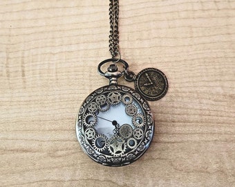 May include: A bronze pocket watch necklace with a white face and intricate gear designs. The watch has a small round pendant with Roman numerals.