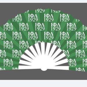 May include: A white folding fan with a green and white pattern. The pattern features the letters "ΙΦΛ" and the year "1929" repeated.