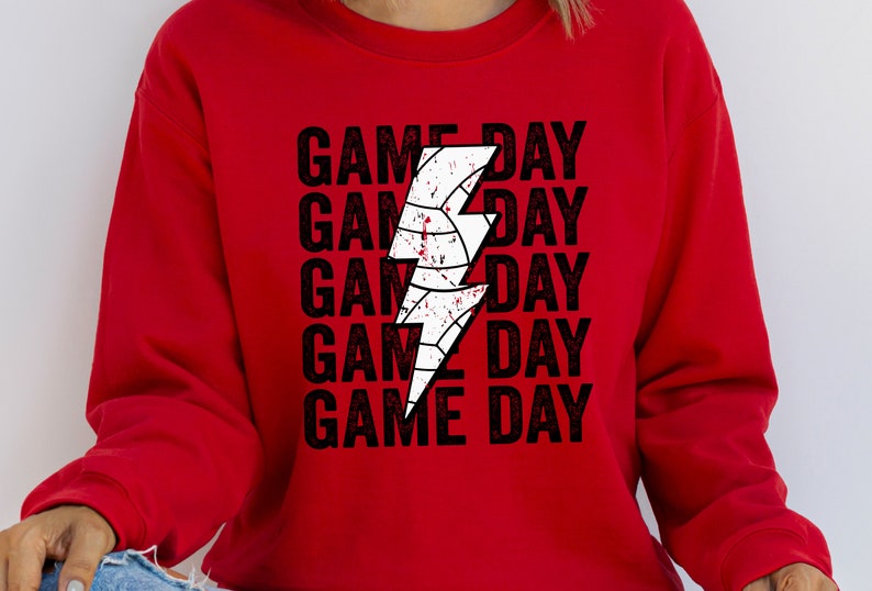 May include: Red sweatshirt with a white lightning bolt graphic and the text "GAME DAY" repeated five times.