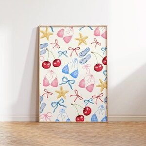 May include: A framed print with a white background and a repeating pattern of cherries, blue and pink bikinis, starfish, and red and blue bows.