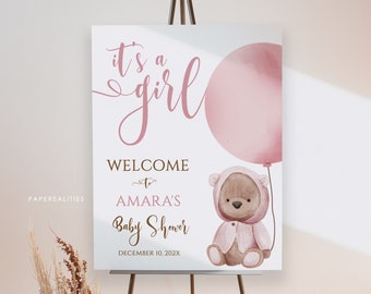 May include: It's a girl baby shower welcome sign with a pink balloon and a teddy bear holding a pink balloon. The sign says "Welcome to Amara's Baby Shower December 10, 202X".