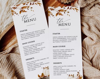May include: A printable Thanksgiving menu template with a fall-themed design. The menu features a starter, main course, and dessert options. The design includes a watercolor illustration of fall leaves and a white pumpkin.
