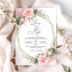 May include: A wedding invitation with the names "Luna and Mike" in elegant script. The invitation features a gold geometric frame and is adorned with watercolor roses and greenery. The date and time of the wedding are also displayed.