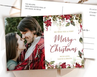May include: A Christmas postcard featuring a couple in a red plaid blanket with a festive floral design and the text "We wish you a very Merry Christmas with love, David & Krista".