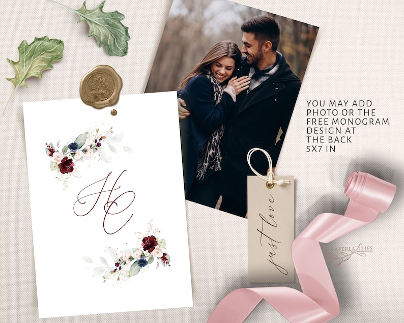 May include: A white card with a burgundy floral design and the letters "H & C" in calligraphy. The card is 5x7 inches and can be personalized with a photo or monogram. The text "just love" is written on a small brown tag.