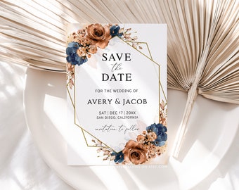 May include: Save the date card with a gold geometric frame and watercolor floral design in shades of brown, blue, and cream. The text reads "Save the Date" for the wedding of Avery & Jacob, Saturday, December 17, 20XX, San Diego, California.  Invitation to follow.