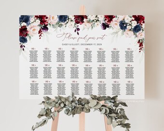 May include: A white wedding seating chart with a floral design in shades of burgundy, blush pink, and navy blue. The text reads "Please find your seat" and "Casey & Elliot | December 17, 202X".