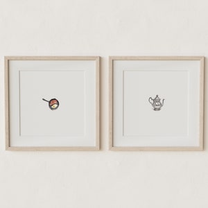 May include: Two framed illustrations, one depicting a frying pan with a fried egg and bacon, the other depicting a silver teapot.