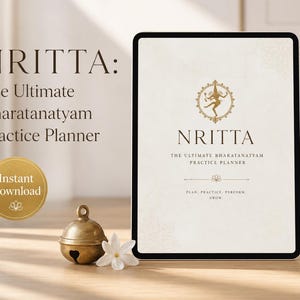 May include: A digital tablet displaying the cover of the "NRITTA: The Ultimate Bharatanatyam Practice Planner." The design features a gold emblem and text on a cream background. A small brass bell and white flower sit beside the tablet. The words "Instant Download" are also visible.