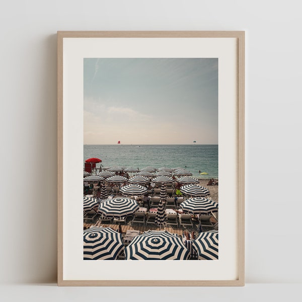 Summertime at Ruhl Plage, Nice | Striped Umbrella Canopy | Chic Beachside Bliss | Riviera Sunbathing Scene | Elegant Seaside Decor