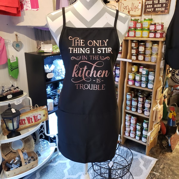 The only thing I stir in the kitchen is trouble apron. Many design colors to choose from.  Who's trouble? You're trouble! NEW APRON STYLE!