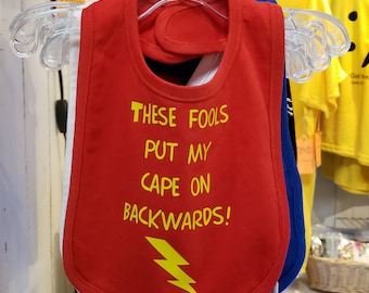 Infant bib: These fools put my cape on backwards, 100% cotton with hook and loop closure. Baby humor | superhero | caped crusader