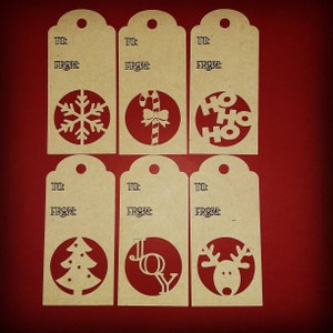 May include: Set of six kraft paper gift tags with cut-out holiday designs. Each tag has a circular design featuring a snowflake, candy cane, "HO HO HO", Christmas tree, "JOY", and a reindeer. The tags include "TO:" and "FROM:" text.