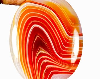 May include: Oval shaped agate cabochon with a red, orange, and white banded pattern.