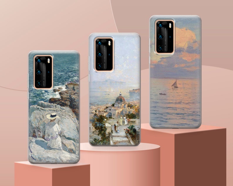 May include: Three phone cases with different scenic paintings. The first case features a seascape with a woman in a hat sitting on a rocky shore. The second case shows a cityscape with a church and buildings. The third case depicts a seascape with a sailboat in the distance.