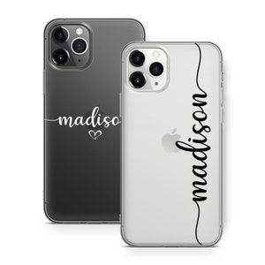 May include: Two phone cases, one black and one clear, with the name "madison" in cursive script. The black case has a heart symbol below the name. The clear case has the name "madison" vertically along the side.