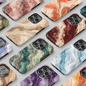 May include: A collection of smartphone cases featuring diverse marbled patterns in various colors including purple, pink, orange, teal, olive green, beige, deep red, blue, and brown, each with a triple camera cutout on the upper left corner.