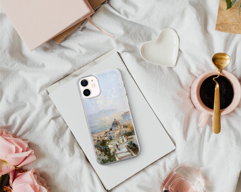 May include: A clear phone case with a painting of a cityscape on a white background. The painting features a white building with a dome and a blue sky.