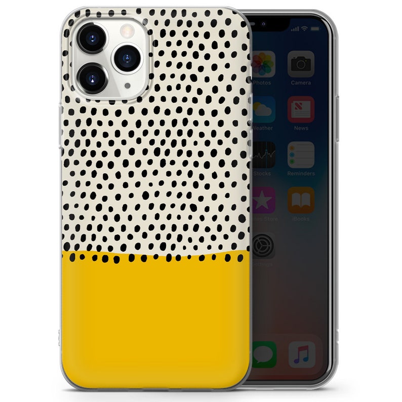 May include: A clear phone case with a white background and black polka dots. The bottom half of the case is yellow.
