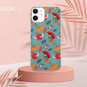 May include: A clear phone case featuring a colourful pattern of red apples, green leaves, brown beetles, yellow umbrellas, and a girl wearing a red hat and blue jacket. The pattern is repeated on a blue background.