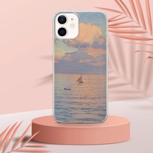 May include: A clear phone case with a painting of a sailboat on a body of water with a cloudy sky. The phone case is on a pink surface.