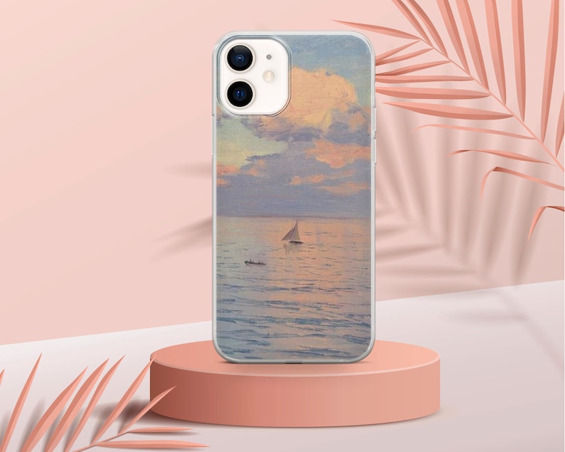 May include: A clear phone case with a painting of a sailboat on a body of water with a cloudy sky. The phone case is on a pink surface.