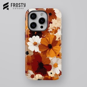 May include: A smartphone case featuring a vibrant floral pattern with large blossoms in shades of burnt orange, deep maroon, cream, and white. The design covers the entire back of the case, which has a cutout for a triple-lens camera system.