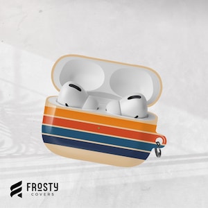May include: An open white wireless earbud charging case featuring a horizontal striped pattern in shades of orange, blue, and cream. The case includes a small metal ring attachment on the side and contains two white earbuds. The text Frosty Covers is visible.