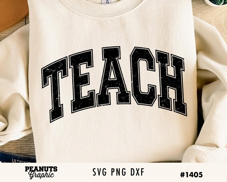 May include: A white sweatshirt with the word "TEACH" in black block letters with a distressed look. The letters are arched and have a thick outline.