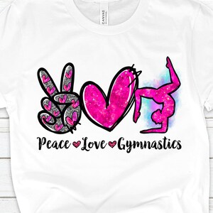 May include: White t-shirt with a pink peace sign, heart, and a gymnast in a backbend pose. The text "Peace Love Gymnastics" is printed below the images.