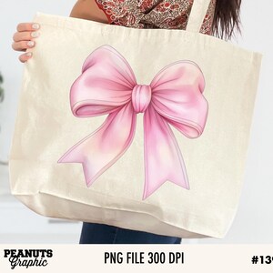 May include: A white tote bag with a pink bow illustration. The bow is large and has a watercolor effect.