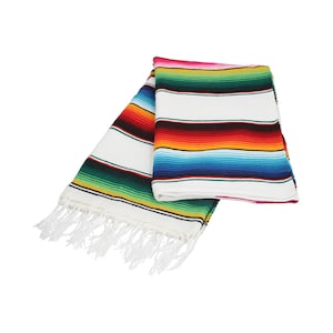 May include: A colorful Mexican blanket with white fringe. The blanket has stripes of red, orange, yellow, green, blue, and purple.