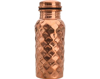 May include: A copper water bottle with a hammered, diamond-shaped pattern. The bottle has a copper lid with a black rubber seal.