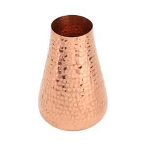 May include: A hammered copper vase with a wide mouth and a narrow base. The vase has a warm, metallic finish.