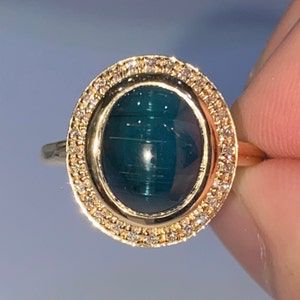 Natural Cat&#39;s Eye Indicolite Tourmaline 3.836 carat Surrounded by Natural Diamonds 0.24 carat on 14K yellow Gold ring